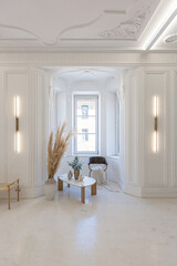 bright interior design of spacious living room with white walls and decorative unique historical moldings on ceiling stylish modern furniture in warm colors without people daylight through the windows