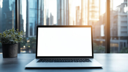 Fototapeta premium Mock up of a white screen laptop placed on a table. Skyscraper background 