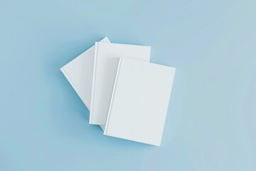 Flat lay of three white notepads on pale blue background, product mockup
