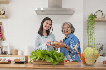 Happy family in the kitchen, Mother and her adult daughter are preparing proper meal