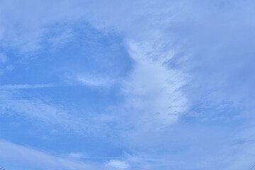 Blue sky view with few white clouds on sunny weather day