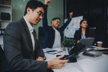 Group of colleagues engaging in a discussion during a business meeting in a conference room. Happy business people, men and women, collaborating and working towards their shared goals.