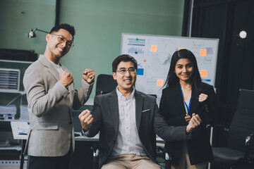 Group of colleagues engaging in a discussion during a business meeting in a conference room. Happy business people, men and women, collaborating and working towards their shared goals.