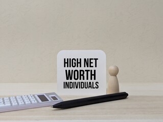 wooden doll , calculator and pen with the words High Net Worth Individuals