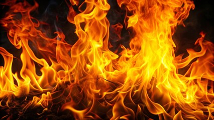 Fototapeta premium Vibrant flames engulf a dark background, dancing tongues of orange and yellow fire illuminating the surrounding air with intense heat and light.