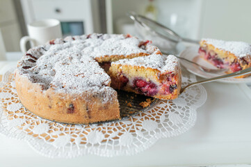 Delicious fresh and homemade baked plum cake on white table background.