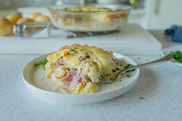 Homemade potato casserole on kitchen counter background