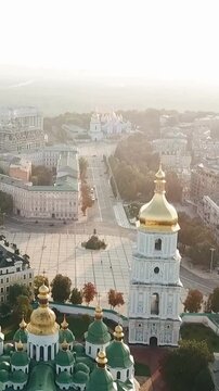 Saint Sophias Cathedral, square with Bohdan Khmelnytsky Monument. Kiyv Ukraine with Places of Interest. Aerial vertical drone video footage. City panarama. Summer time. Dnipro river and bridge