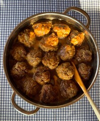 Dutch Grandma's meatballs in pan filled with gravy