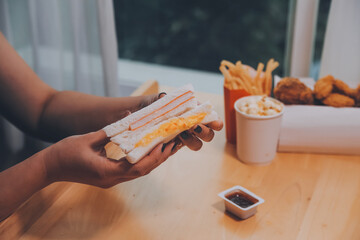 Asian healthy woman have breakfast with sandwich in morning