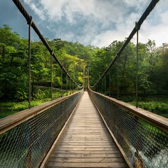 Fototapeta premium 아름다운 숲으로 이어지며 강 아래에 있는 다리, A bridge under a river leading into a beautiful forest