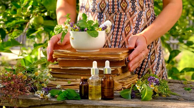 Woman with medicinal herbs in the garden. Selective focus.