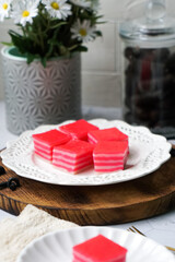 Kuih Lapis, a traditional Malay layered steamed cake and dessert, in white plates.