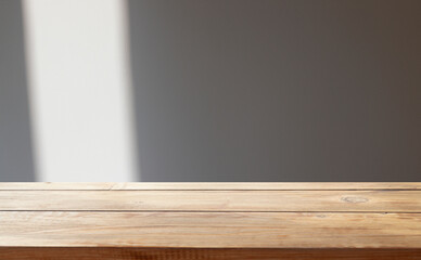 background for overlaying products. Close-up of a round empty oak table with sunlight and tropical plant leaves. Organic beauty, natural concept. Layout, podium, spa, sunscreen.