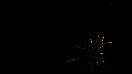   black background with a blot in the form of fireworks of different colors in the lower right corner  