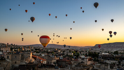 Hot air balloons flying above Goreme, Cappadocia, Turkey at dawn © Ian