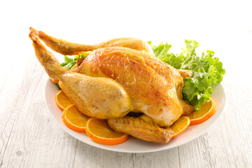 whole roast chicken with oranges slices