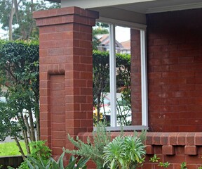 Decorative brick work on the column and front verandah of an old house on Sydney 