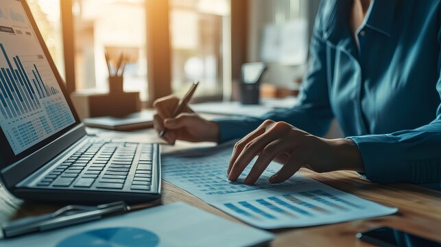 Businessman analyzing a marketing plan while an accountant calculates financial reports using a computer with graph charts Concepts related to business finance and accounting