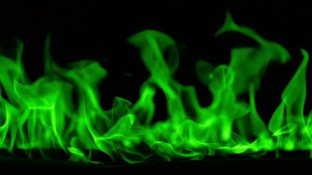 Magical Green Fire. Green Fire burning. Bright burning flames on a black background. Fire in slow motion. Wall of Real fire, abstract background. Super slow motion video