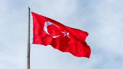 Turkish national flag hang on a pole in open air.