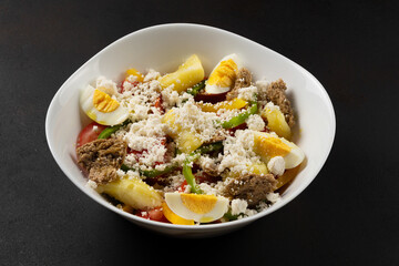 Fresh salad - tomatoes, eggs, feta cheese and paprika. Greek salad with olive oil.