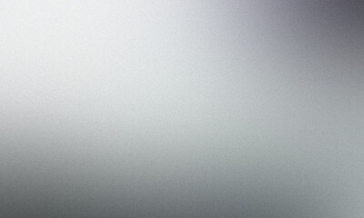 Metallic surface with a grainy texture fading to dark from a bright light source