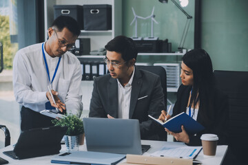Group of colleagues engaging in a discussion during a business meeting in a conference room. Happy business people, men and women, collaborating and working towards their shared goals.
