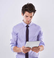 Tablet, research and business man in studio scroll for online planning, website review and social media. White background, corporate and worker on digital technology for email, internet or networking