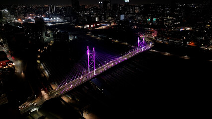 Obraz premium Nelson Mandela Bridge At Johannesburg In Gauteng South Africa. City At Night Landscape. Illuminated Cable Bridge. Johannesburg At Gauteng South Africa. Landmark Buildings. Colored Bridge.