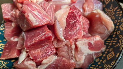 Pork goulash for home cooking cut into large cubes. Home cooking, raw meat.