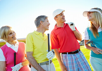 Golf course, group and happy couple of friends outdoor for sport and game discussion with clubs. Golfers, team and people in nature for exercise, hobby and conversation to compare competition score