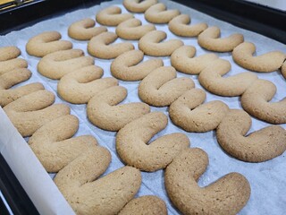Buttery Crescent-Shaped Cookies with Powdered Sugar on Baking Sheet or in Box