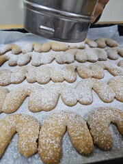 Buttery Crescent-Shaped Cookies with Powdered Sugar on Baking Sheet or in Box