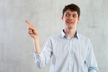 Portrait of young guy gesturing in studio