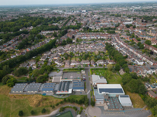 Green energy with solar panels on the roof of primary school in Swindon UK. Aerial view on...