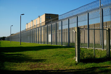 High security fence with spiky Nato wire rolls on top at a German prison in Hanover, Lower Saxony,...