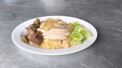 Chicken rice in a white plate on the dining table