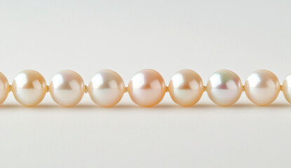 A horizontal line of pearls on a white background