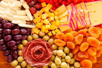 cheese on table with snacks - party buffet with various savory foods