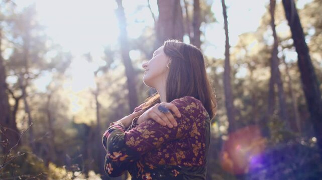 young and beautiful girl in a dress among natural landscapes. A young and beautiful girl dances and sings in the forest among the trees. girl alone with nature.