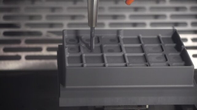 The CNC milling machine rough cutting at concave the graphite electrode parts.