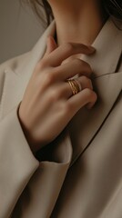 Elegant hand showcasing rings on a neutral backdrop in a stylish fashion setting