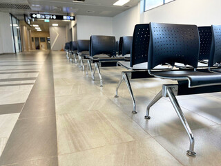  rows of airport chairs in a modern terminal, clean, sleek design of seating arrangements often seen in airports, providing a calm and organized environment,  travel, transportation, airport design
