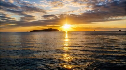 Fototapeta premium Golden Sunset Over Water with Island Silhouette and Boats