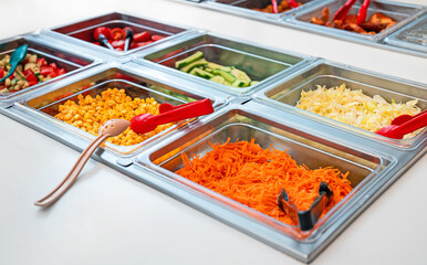 Vegetables in the canteen in metal containers.