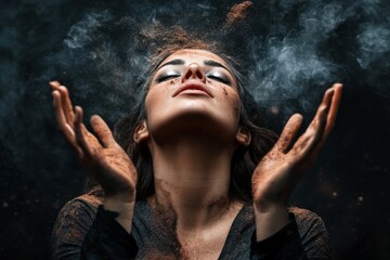 A person raising hands into the air with dust particles scattering, captured in a dramatic dark atmosphere, representing freedom, mysticism, and human connection with nature.