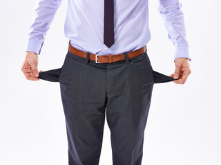 Businessman, hands and pants with empty pockets for bankruptcy, debt or financial criss on a white studio background. Closeup of man or broke employee with no money, cash or poor finance in loss