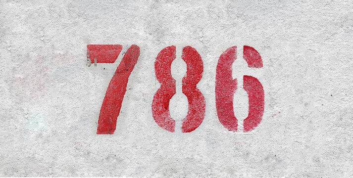 Red Number 786 on the white wall. Spray paint.