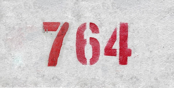 Red Number 764 on the white wall. Spray paint.